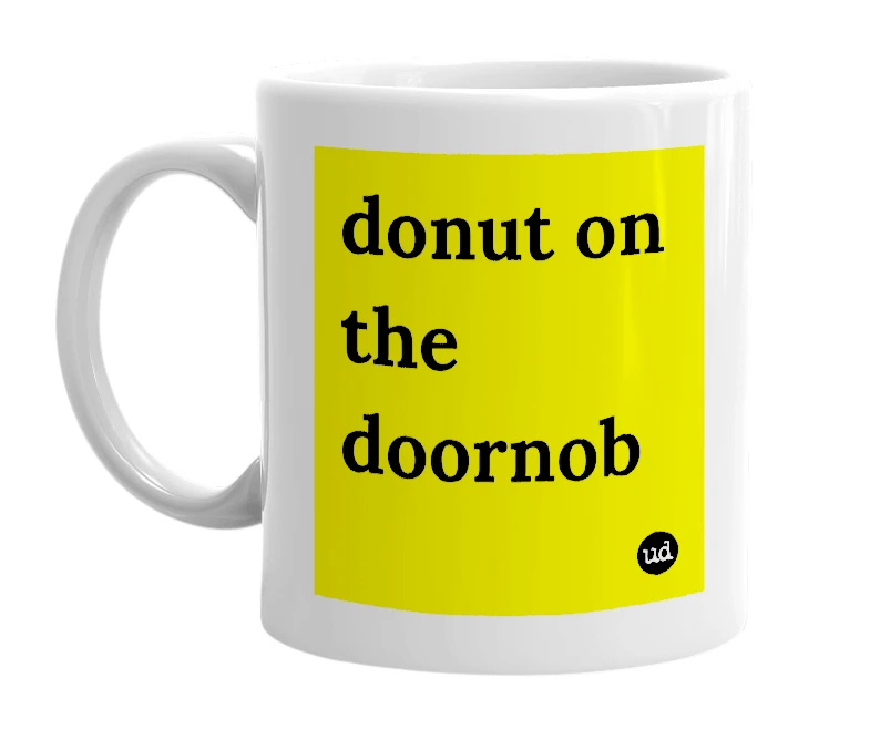 White mug with 'donut on the doornob' in bold black letters