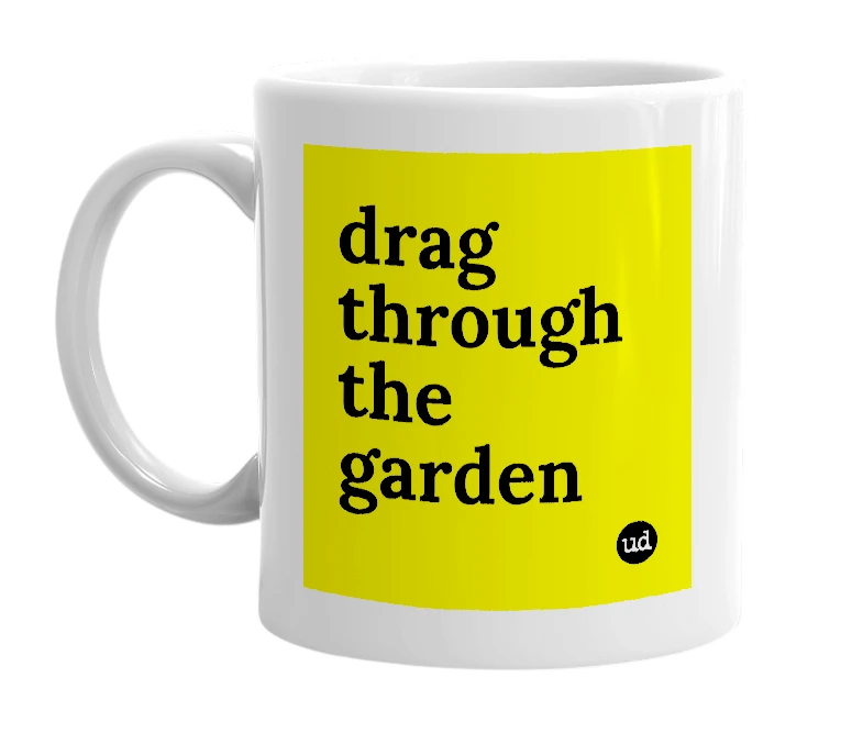 White mug with 'drag through the garden' in bold black letters