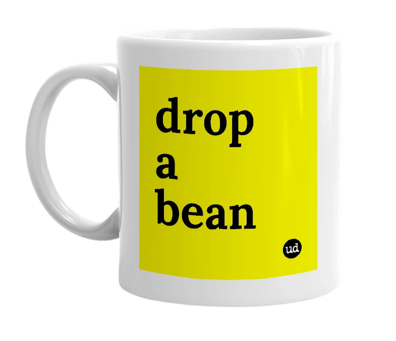 White mug with 'drop a bean' in bold black letters