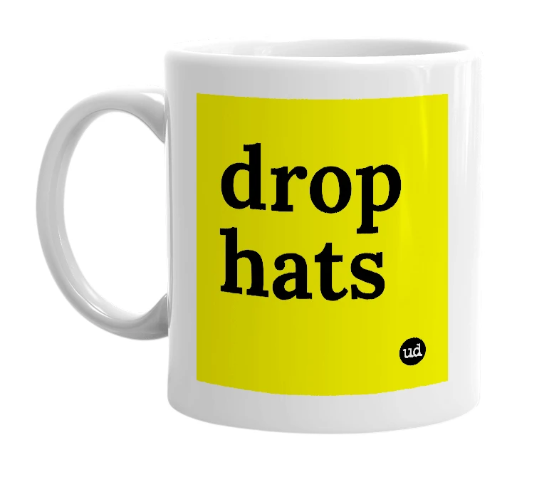 White mug with 'drop hats' in bold black letters