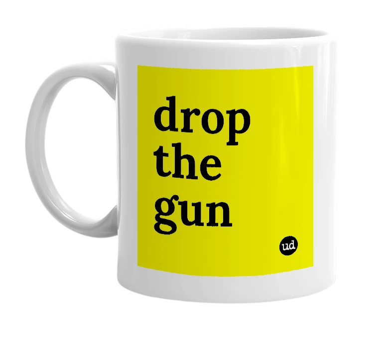 White mug with 'drop the gun' in bold black letters