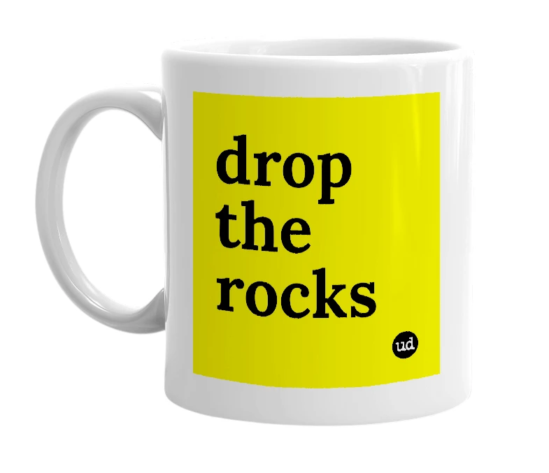 White mug with 'drop the rocks' in bold black letters