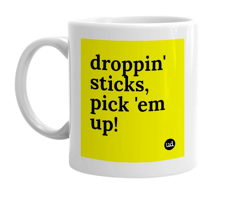 White mug with 'droppin' sticks, pick 'em up!' in bold black letters