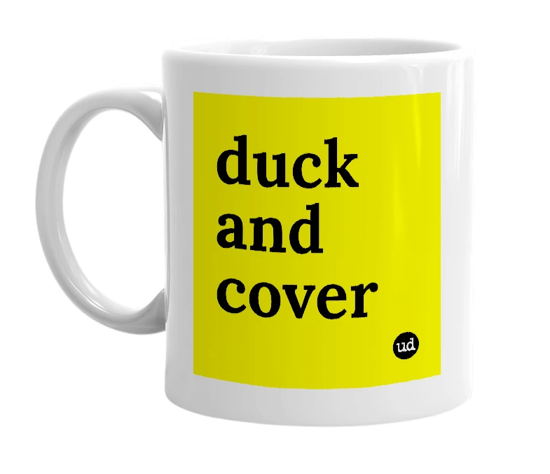 White mug with 'duck and cover' in bold black letters