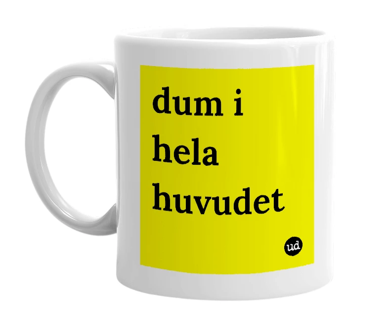 White mug with 'dum i hela huvudet' in bold black letters