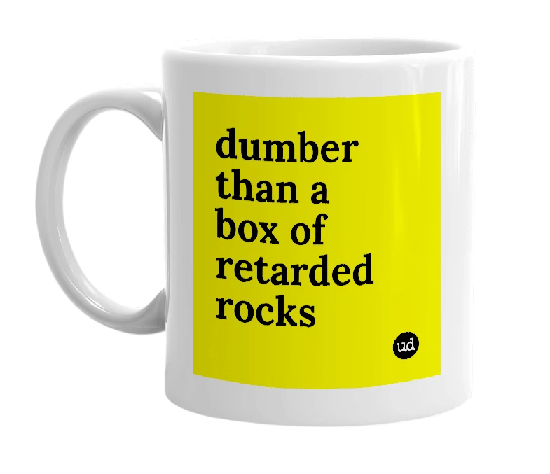 White mug with 'dumber than a box of retarded rocks' in bold black letters