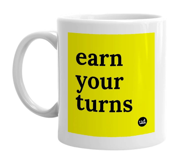 White mug with 'earn your turns' in bold black letters