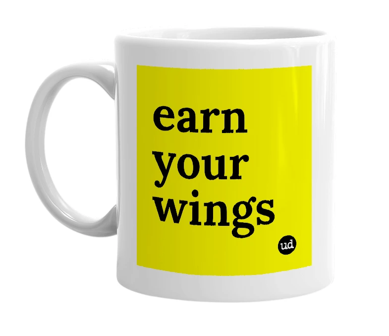 White mug with 'earn your wings' in bold black letters