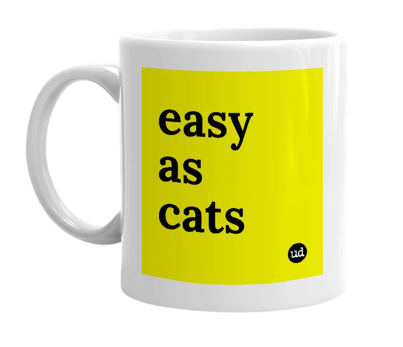 White mug with 'easy as cats' in bold black letters
