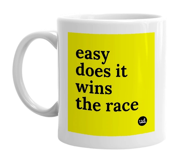 White mug with 'easy does it wins the race' in bold black letters