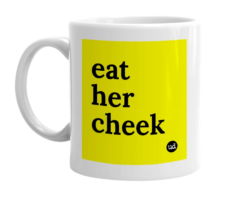 White mug with 'eat her cheek' in bold black letters