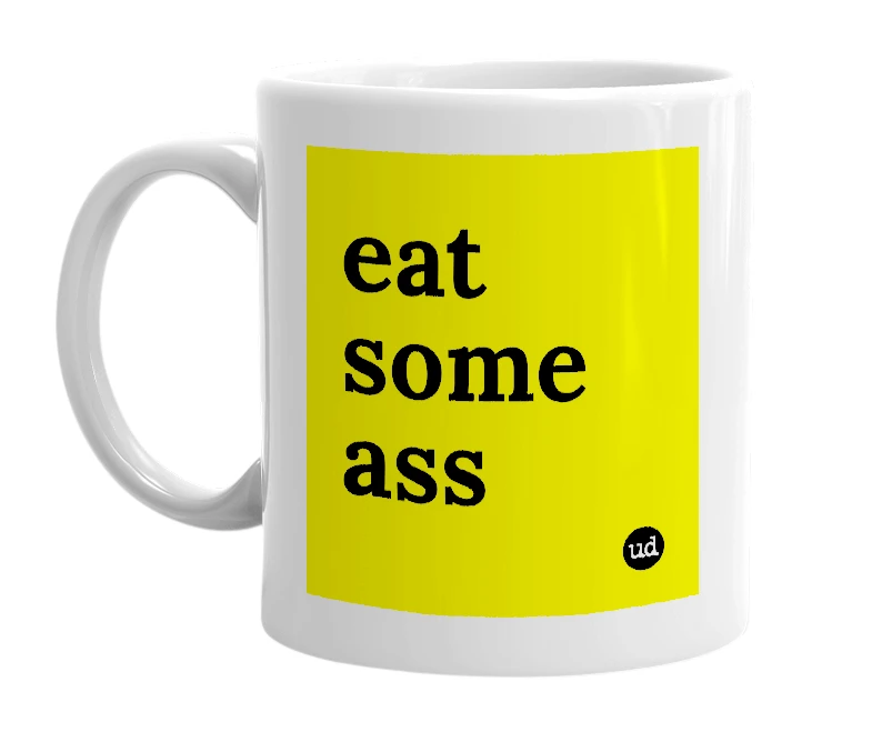 White mug with 'eat some ass' in bold black letters