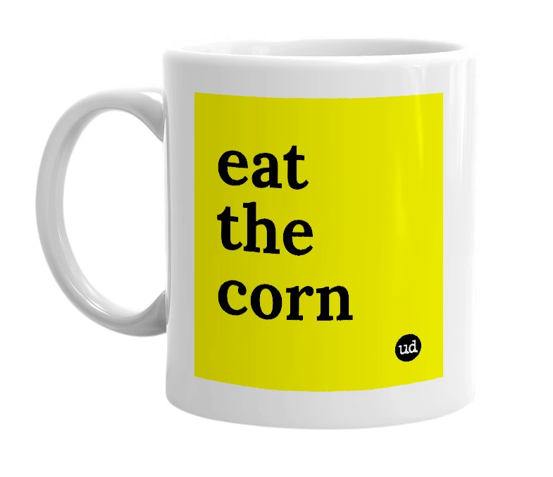 White mug with 'eat the corn' in bold black letters