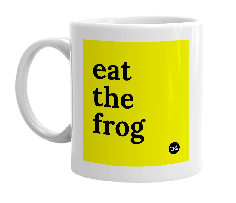 White mug with 'eat the frog' in bold black letters