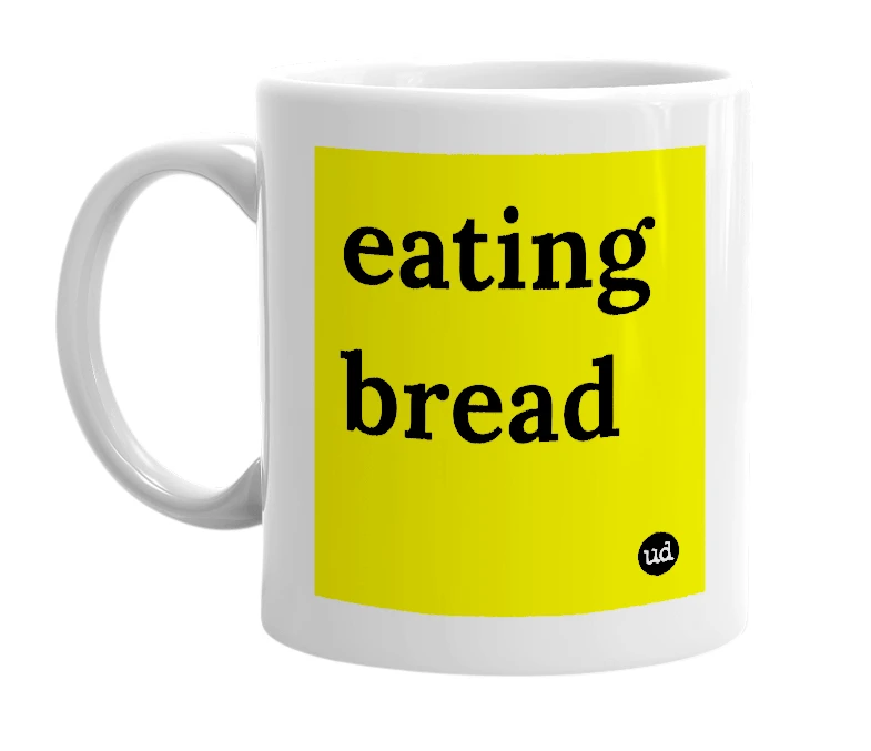 White mug with 'eating bread' in bold black letters