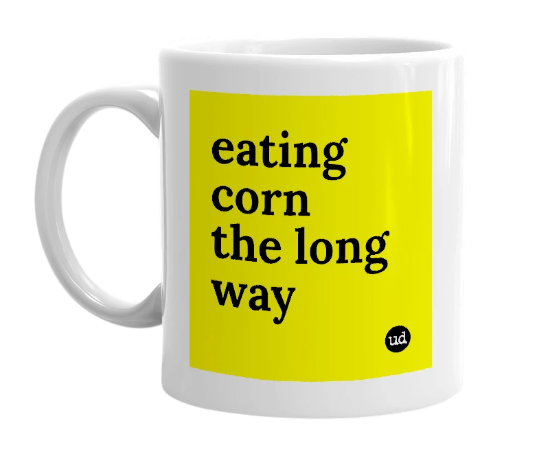 White mug with 'eating corn the long way' in bold black letters