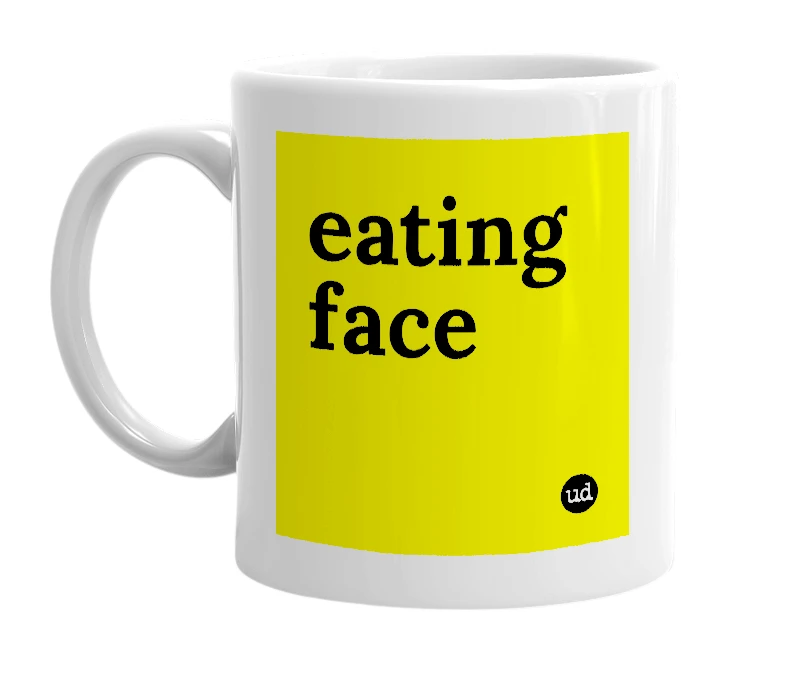 White mug with 'eating face' in bold black letters