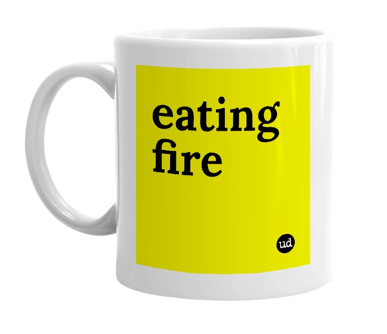 White mug with 'eating fire' in bold black letters