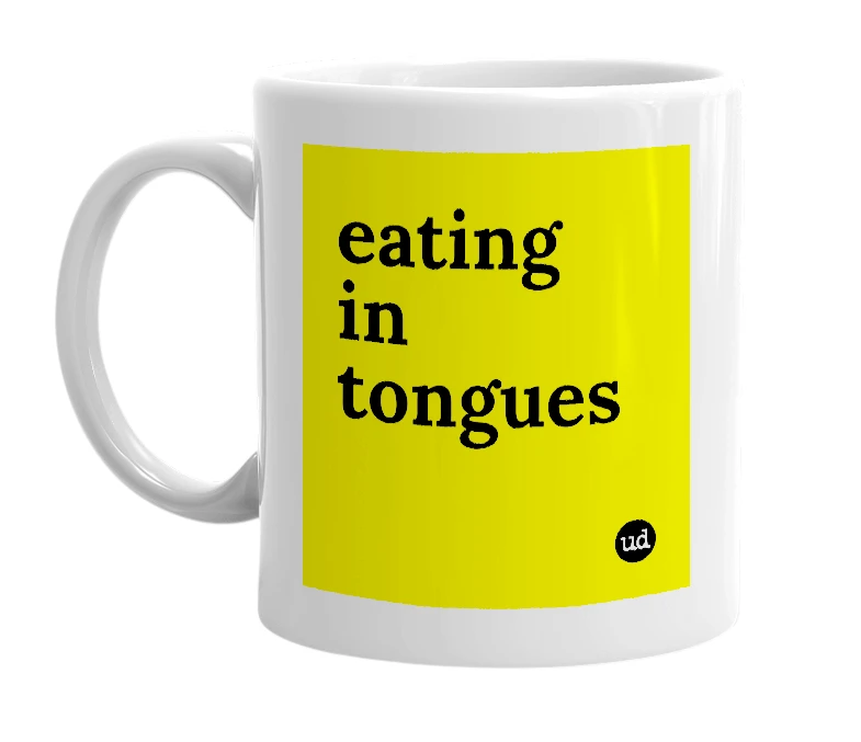 White mug with 'eating in tongues' in bold black letters