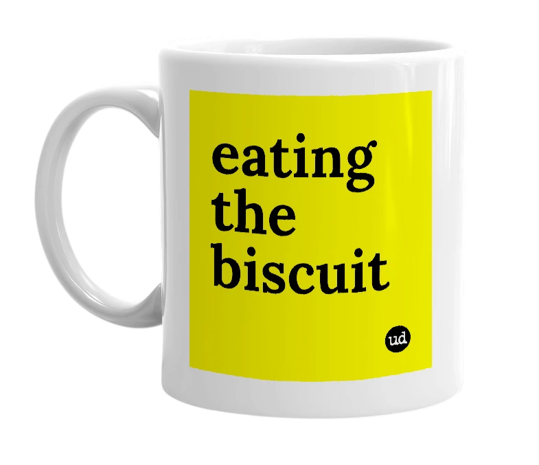 White mug with 'eating the biscuit' in bold black letters
