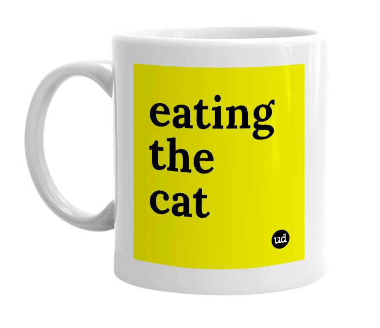 White mug with 'eating the cat' in bold black letters