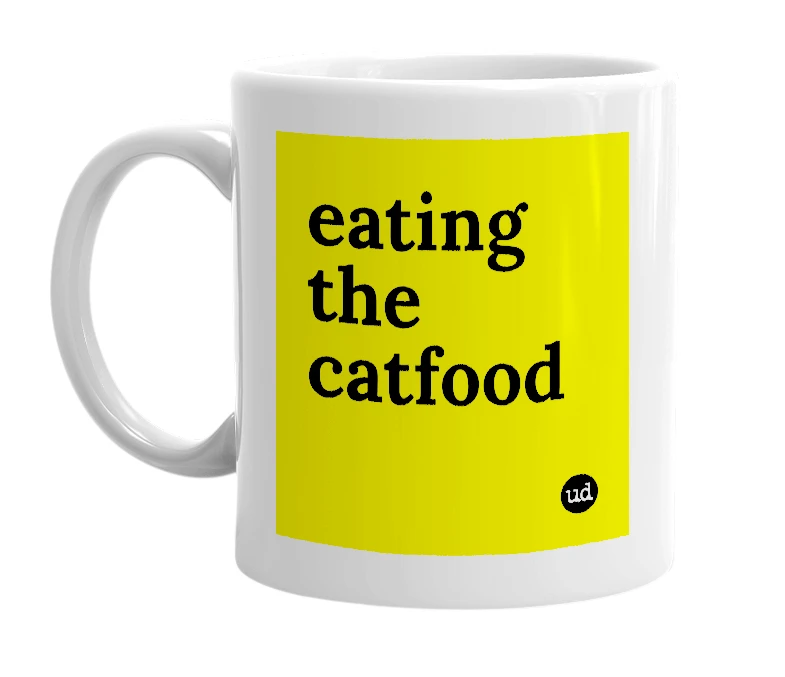 White mug with 'eating the catfood' in bold black letters