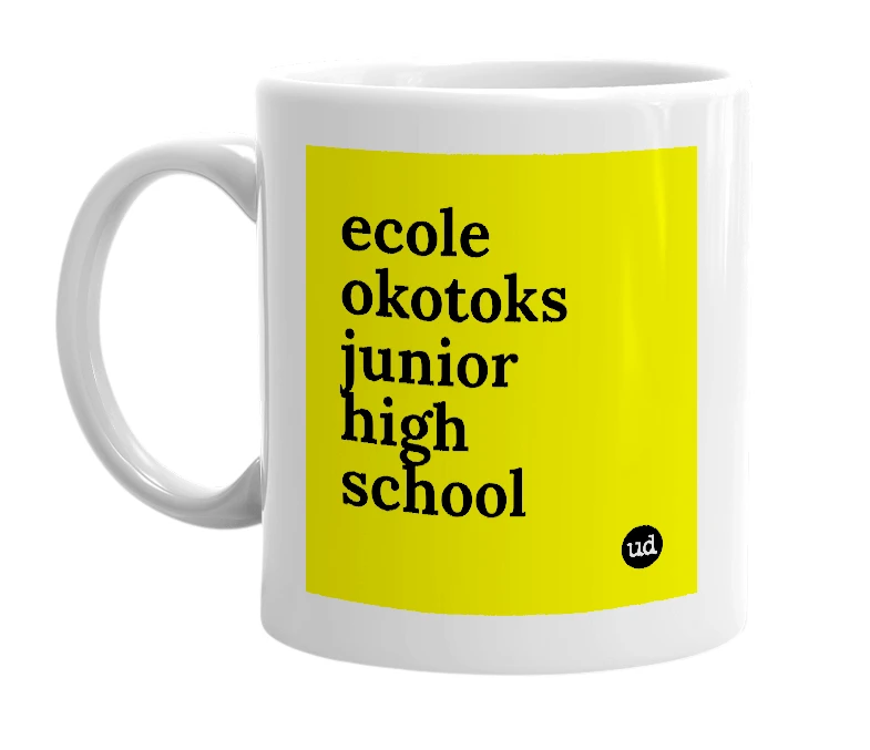 White mug with 'ecole okotoks junior high school' in bold black letters
