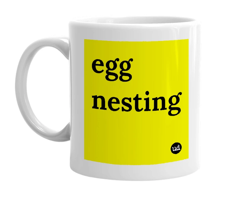 White mug with 'egg nesting' in bold black letters