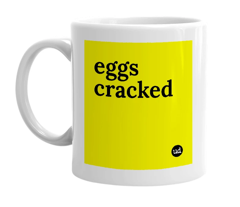 White mug with 'eggs cracked' in bold black letters