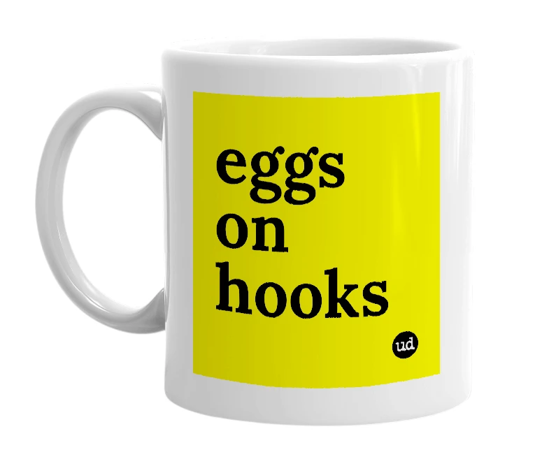 White mug with 'eggs on hooks' in bold black letters