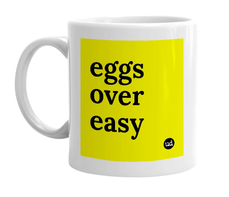 White mug with 'eggs over easy' in bold black letters