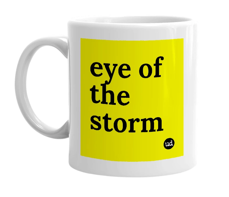 White mug with 'eye of the storm' in bold black letters