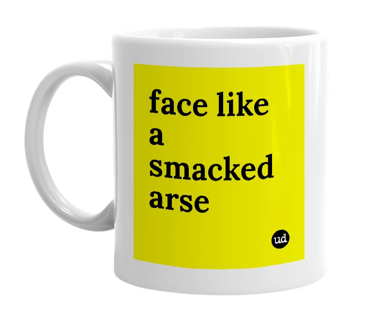 White mug with 'face like a smacked arse' in bold black letters