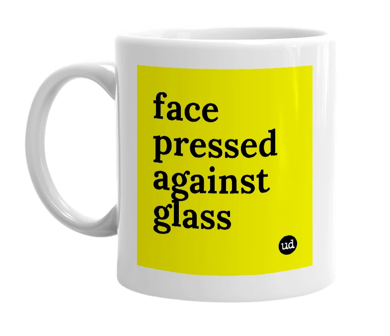 White mug with 'face pressed against glass' in bold black letters