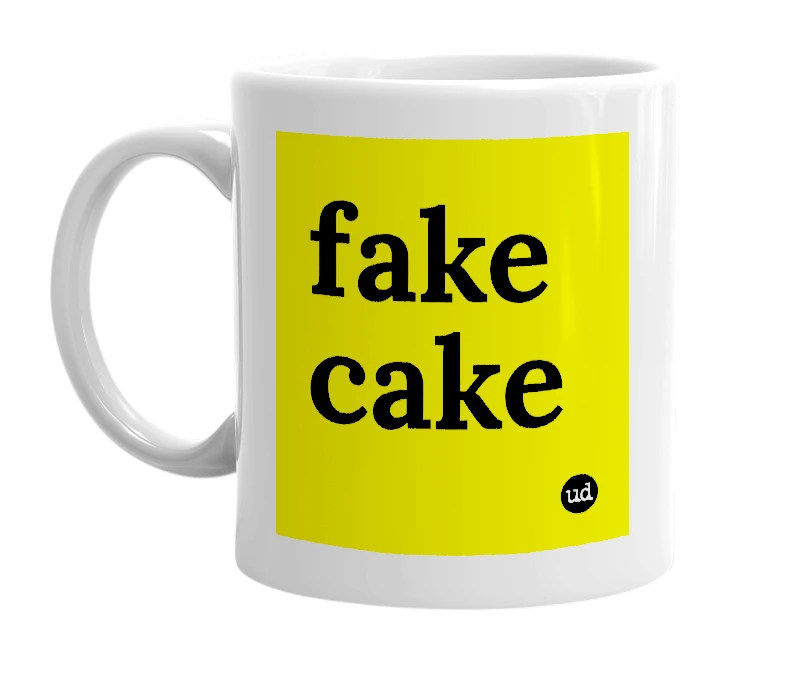 White mug with 'fake cake' in bold black letters