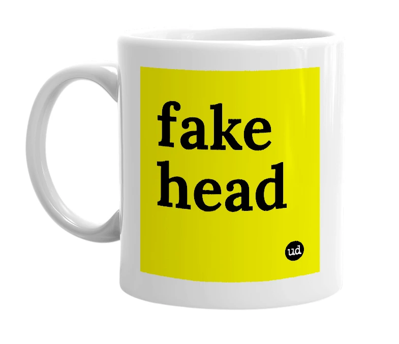 White mug with 'fake head' in bold black letters