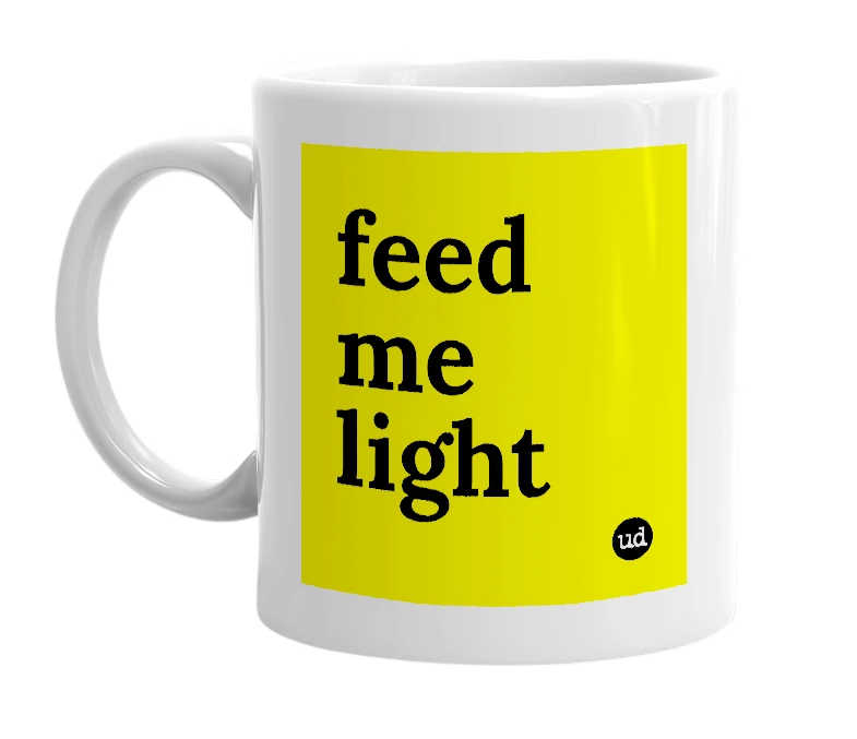 White mug with 'feed me light' in bold black letters