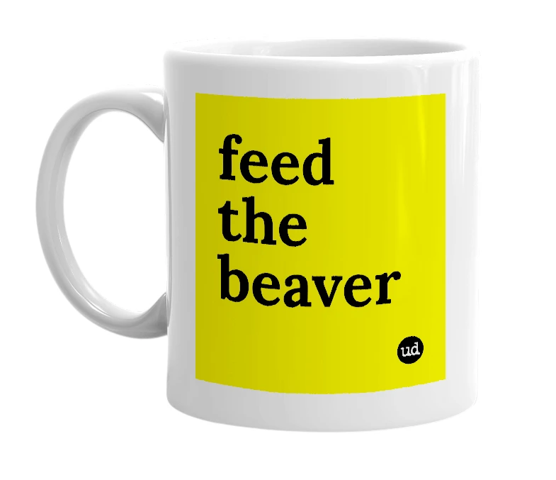 White mug with 'feed the beaver' in bold black letters