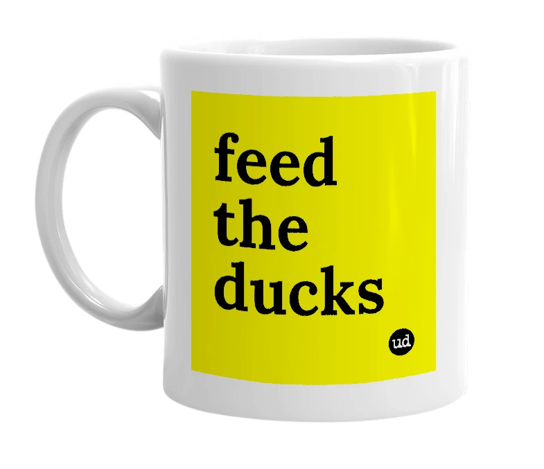White mug with 'feed the ducks' in bold black letters