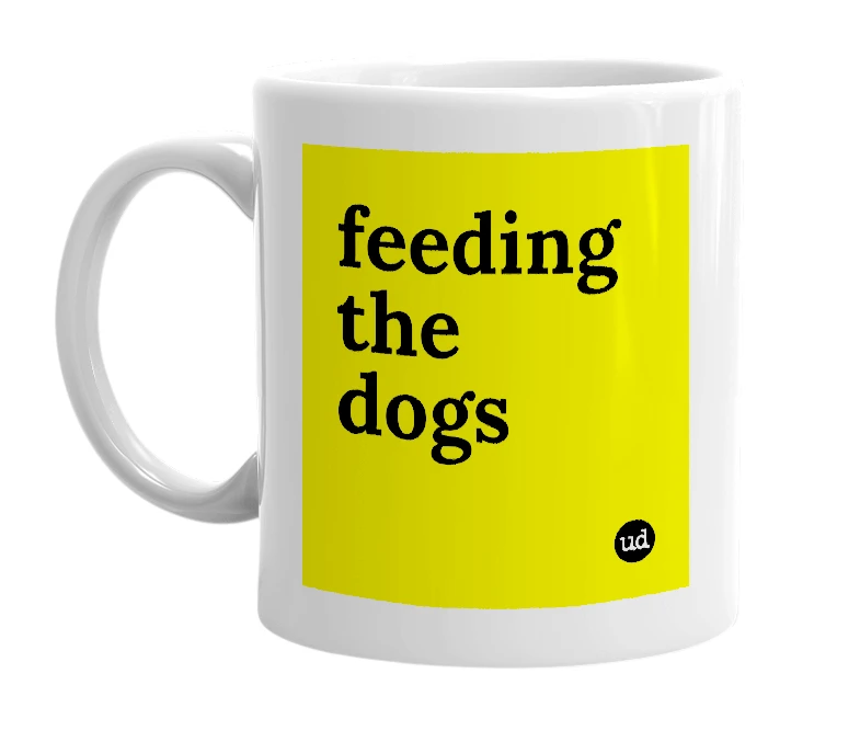 White mug with 'feeding the dogs' in bold black letters