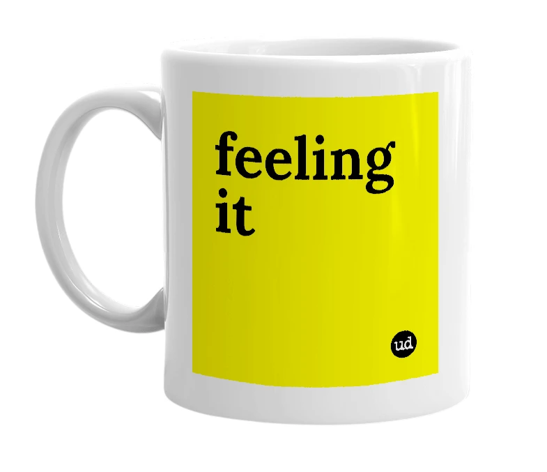 White mug with 'feeling it' in bold black letters