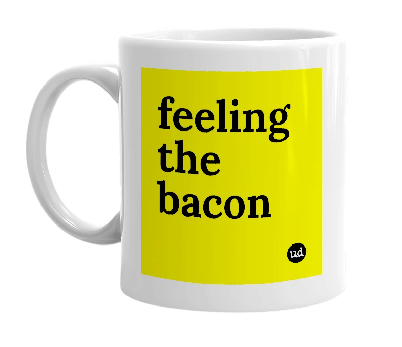 White mug with 'feeling the bacon' in bold black letters