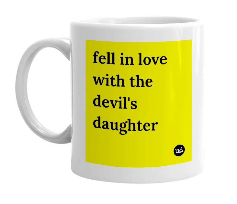 White mug with 'fell in love with the devil's daughter' in bold black letters