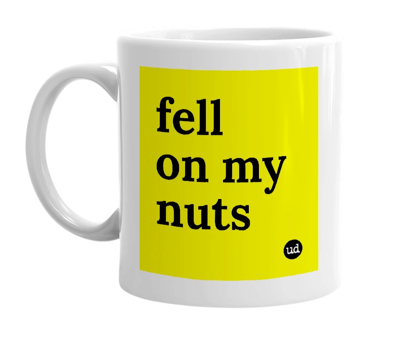 White mug with 'fell on my nuts' in bold black letters