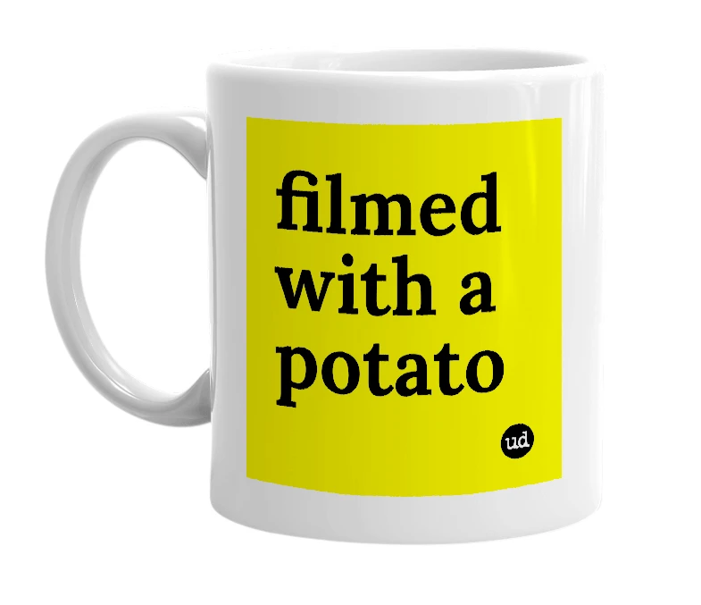 White mug with 'filmed with a potato' in bold black letters