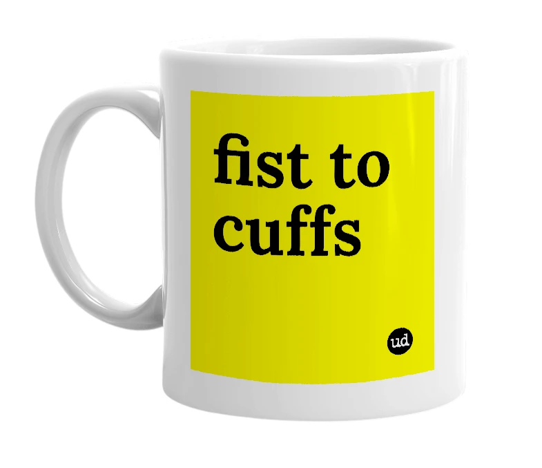 White mug with 'fist to cuffs' in bold black letters