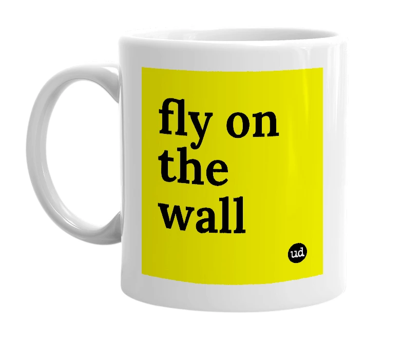 White mug with 'fly on the wall' in bold black letters