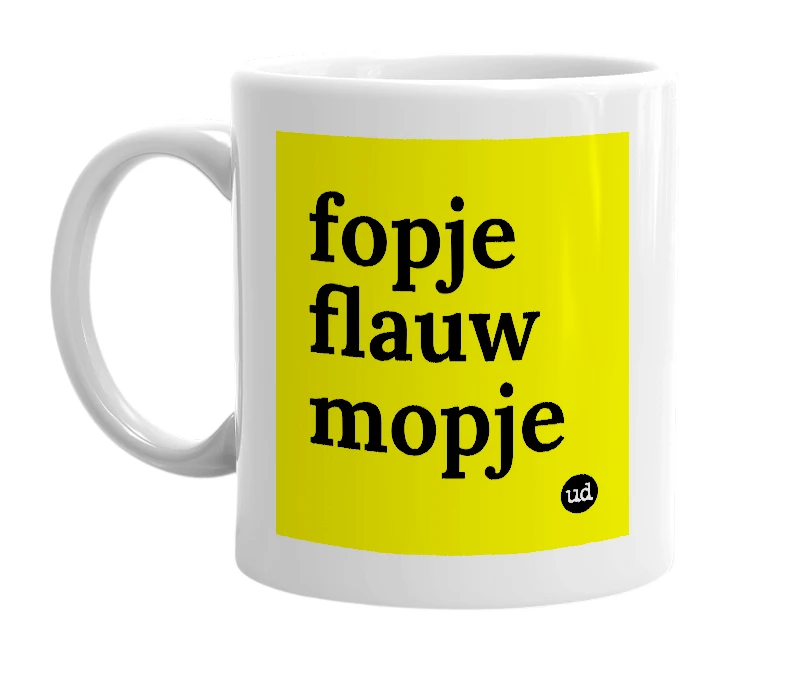 White mug with 'fopje flauw mopje' in bold black letters