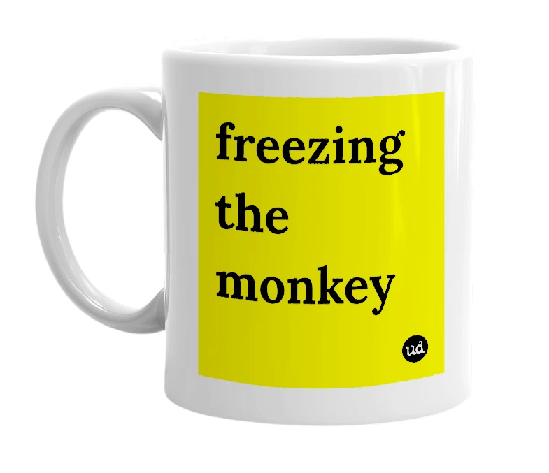 White mug with 'freezing the monkey' in bold black letters