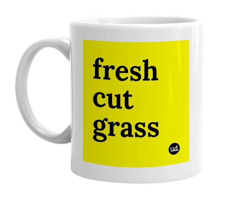 White mug with 'fresh cut grass' in bold black letters